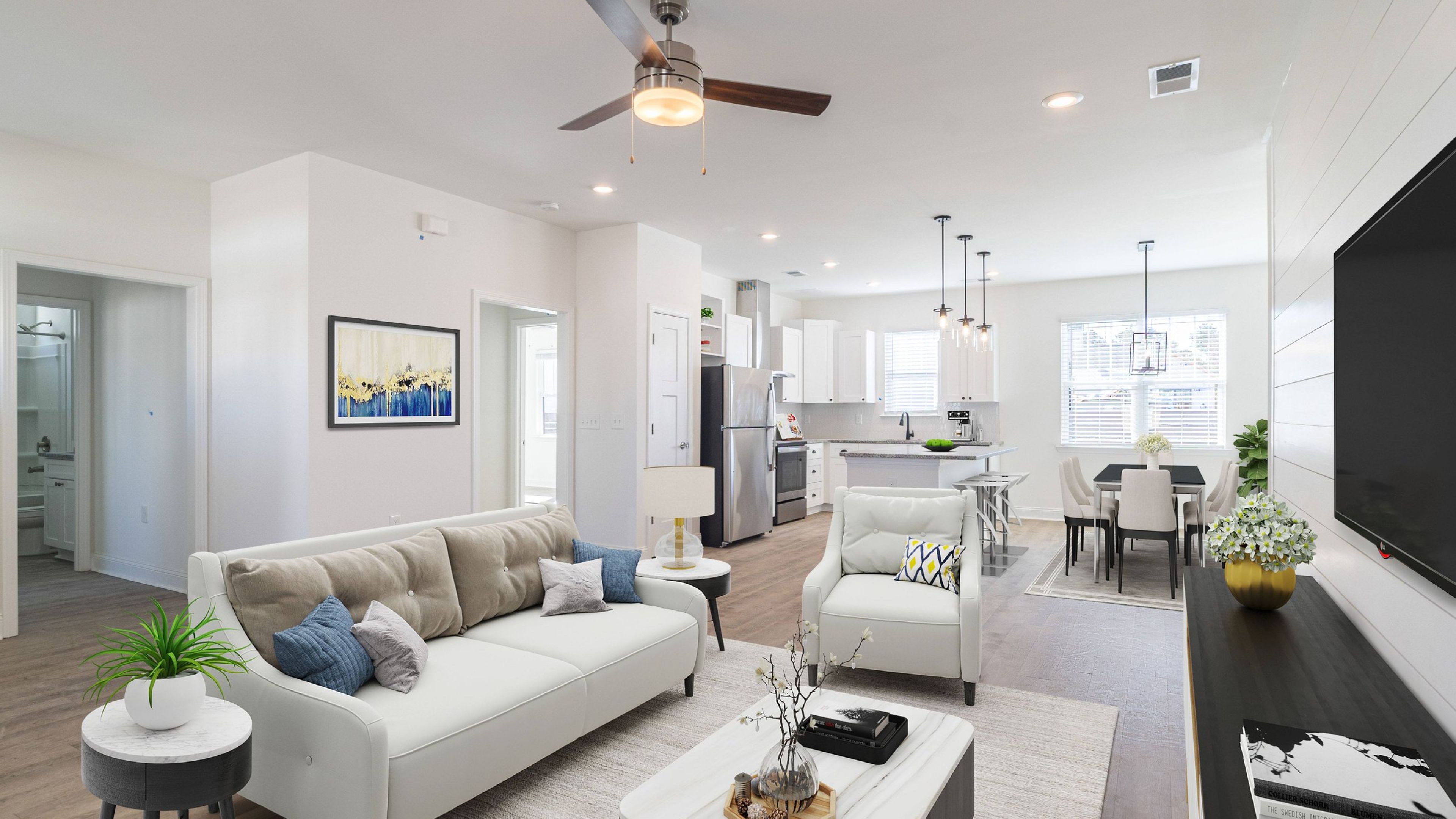 Hawthorne Cottages at Leland home living room with couch, chair, and coffee table, view point looking towards kitchen and dining area
